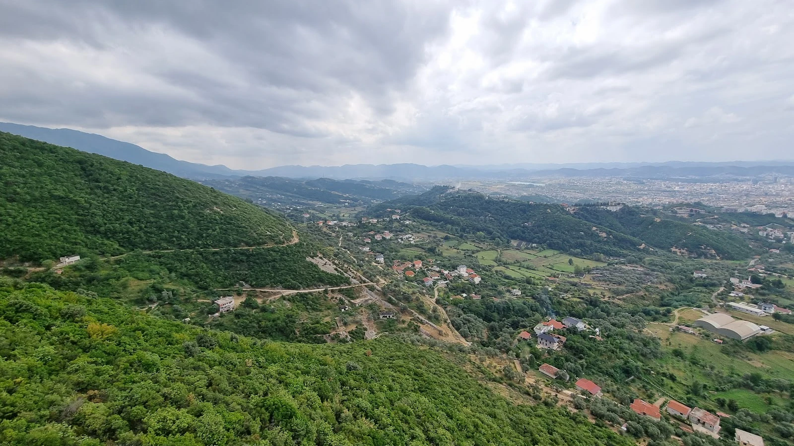 Family car rental scene in Tirana with luggage ready for road trip